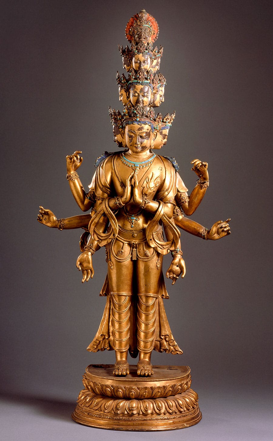 Statue of the Eleven-Headed Avalokiteshvara. It is gold with blue and red accents.