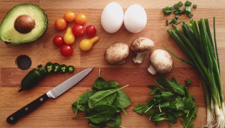 A cutting board full of vegetables.