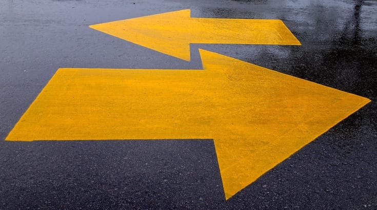 Two opposing arrows on the street.