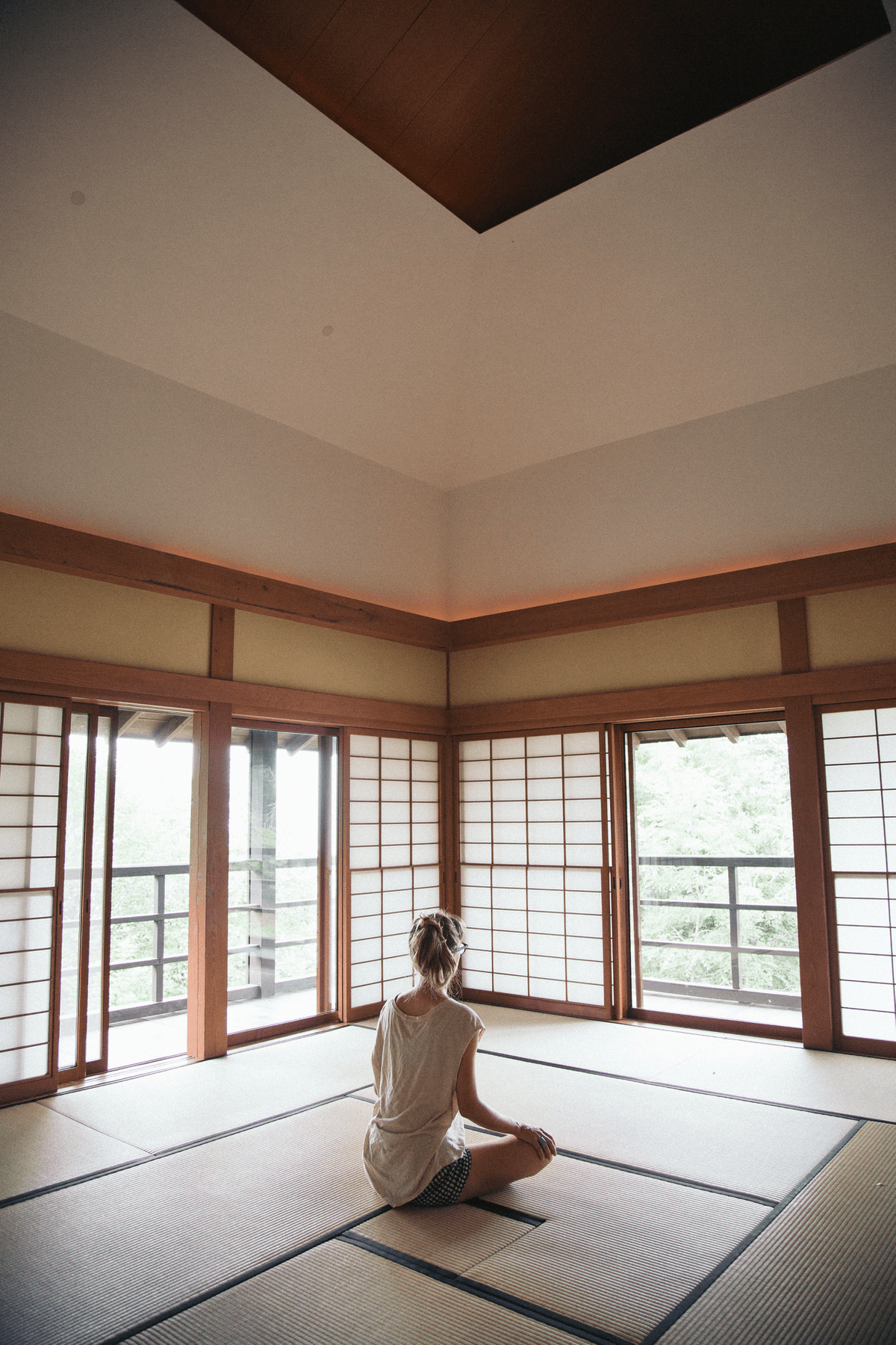Woman sitting in a Zendo.