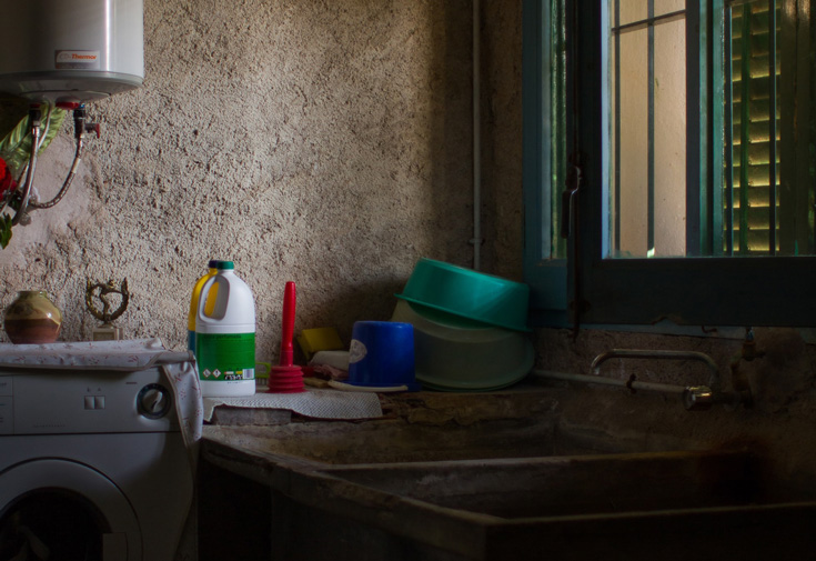 An image of a kitchen. There is a sink and a few dishes and cleaning supplies in the photo.