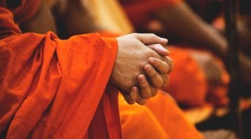 Thai monk with hands folded.