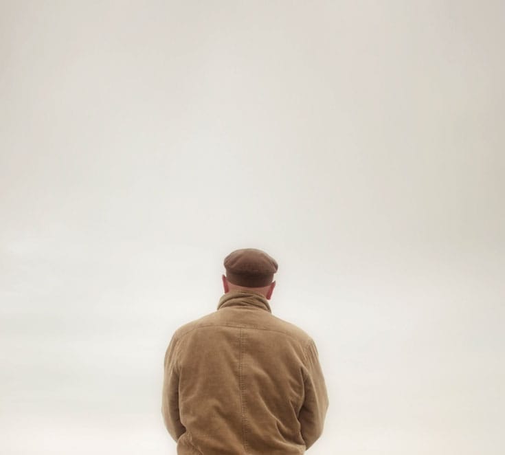 Bored man staring at wall.