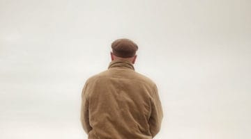Bored man staring at wall.