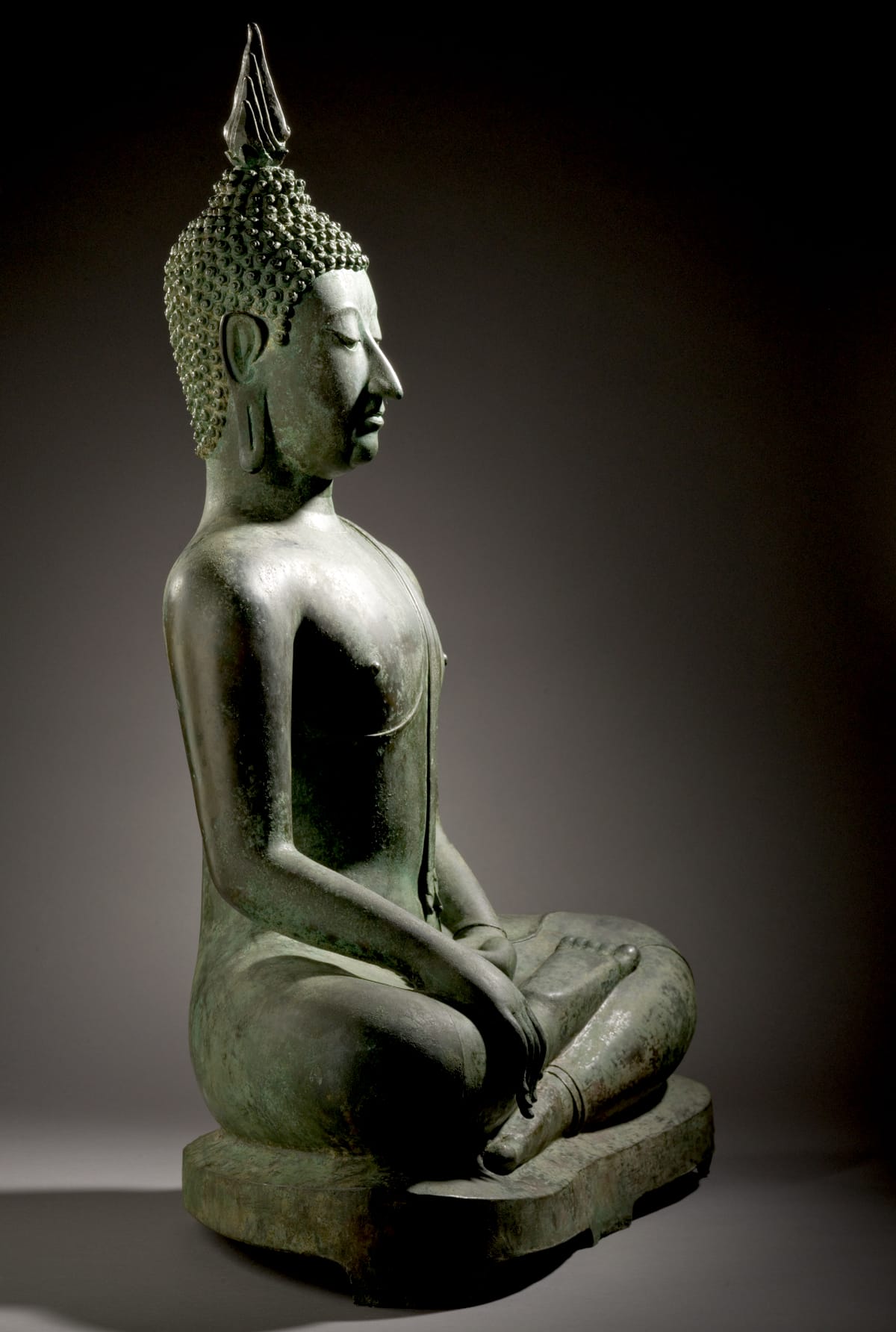 Head and shoulder of a statue of the Buddha in meditation.
