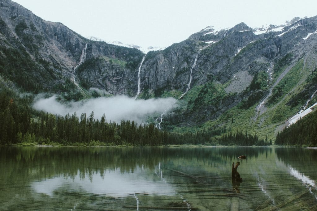 A scenic photo of a lake near mountains.