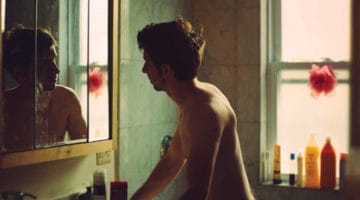 Man staring in the mirror.