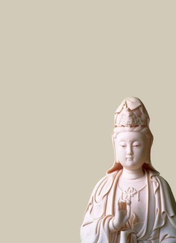 Marble statue against a beige background.