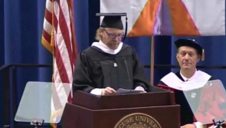 George Saunders speaking at a podium.
