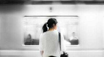 Woman standing in front of a subway.