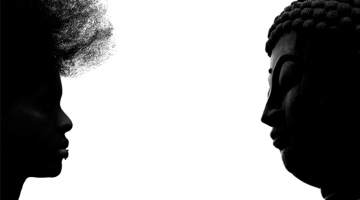 Buddha facing African-American woman.