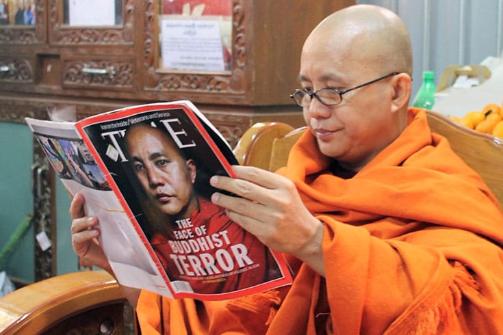 Radical Buddhist monk Ashin Wirathu reading a TIME magazine article about himself.