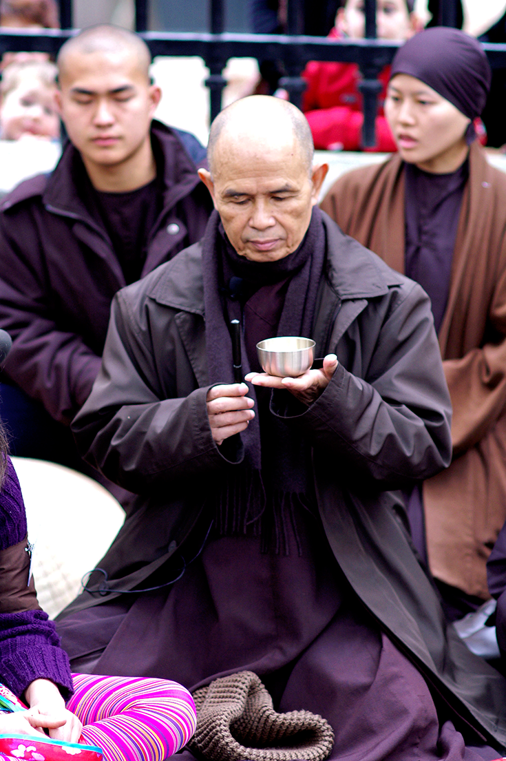 Thich Nhat Hanh holding a singing bowl.