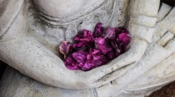 Buddha statue holding flowers.