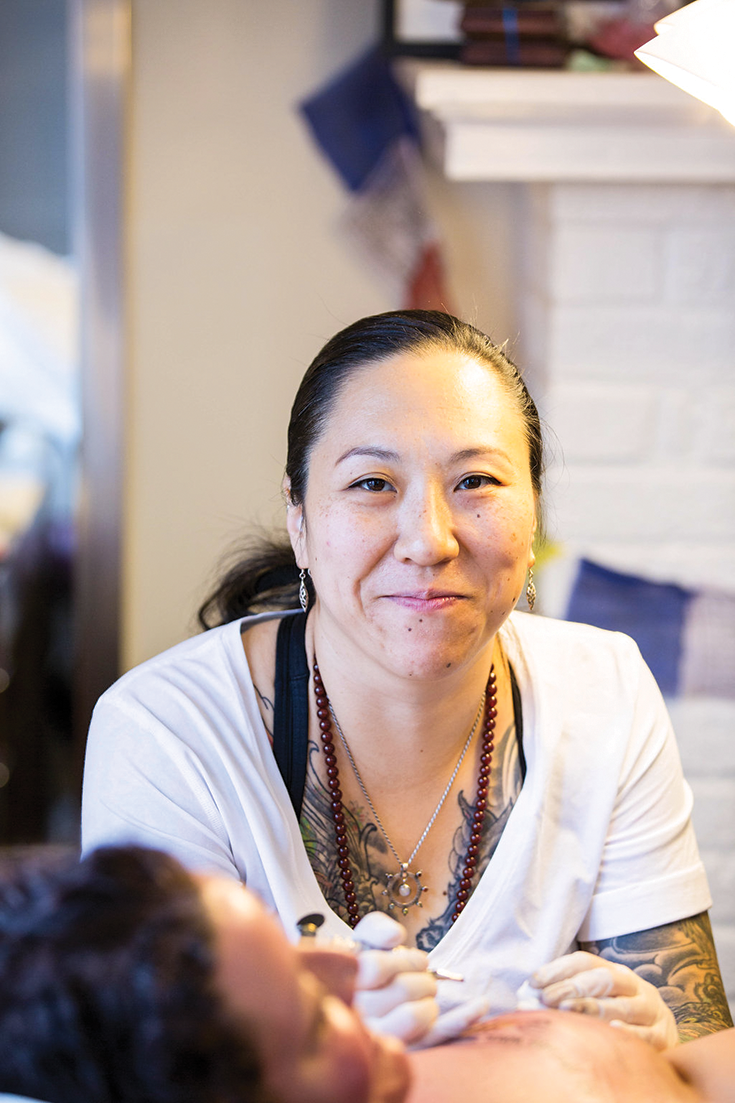 Amy Black tattoos a mastectomy patient.