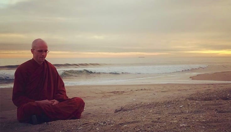 Buddhist monk Bhante Suddhaso meditating on Rockaway Beach.