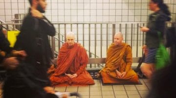 Monks meditating in the New York subway.