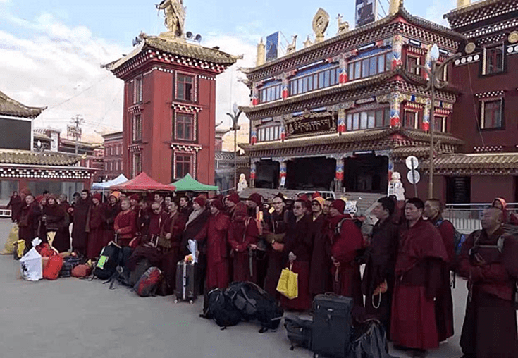 Buddhist monks and nuns wait to be taken away from Larung Gar. Via Radio Free Asia.
