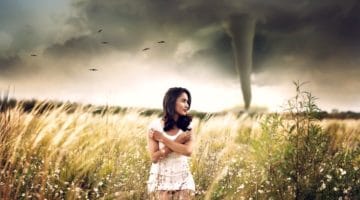 Women standing in front of a tornado.