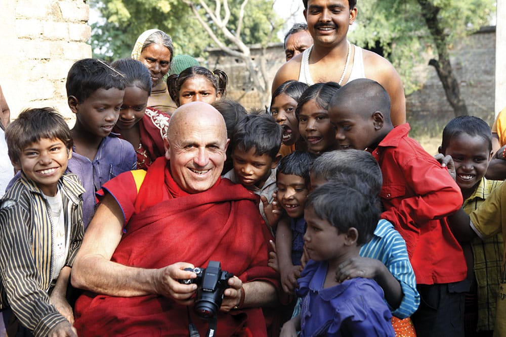 Matthieu Ricard shows his photography to children in one of the remote villages in Bihar, India, that are helped by his humanitarian organization, Karuna-Shechen. Photo by Shamsul Aktar. 