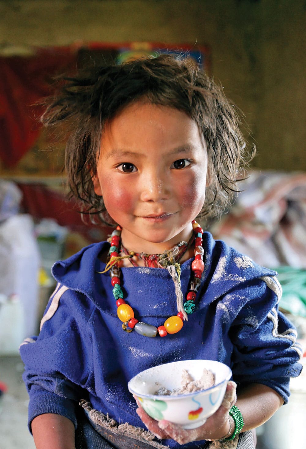 Photo by Matthieu Ricard of a Tibetan girl. “Her image,” says Ricard, “reminds me of the reason we work in Tibet and our mission to bring education and health to the Tibetan people and, especially, to young girls.