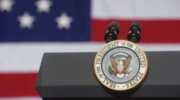 Presidential seal on a podium.