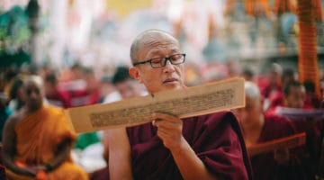 Dzongsar Khyentse Rinpoche reading a Buddhist text.