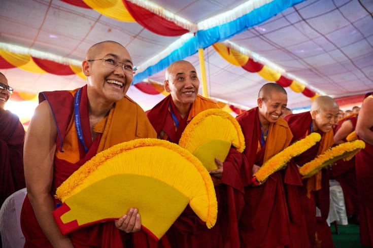 Nuns sitting in the audience, smiling.