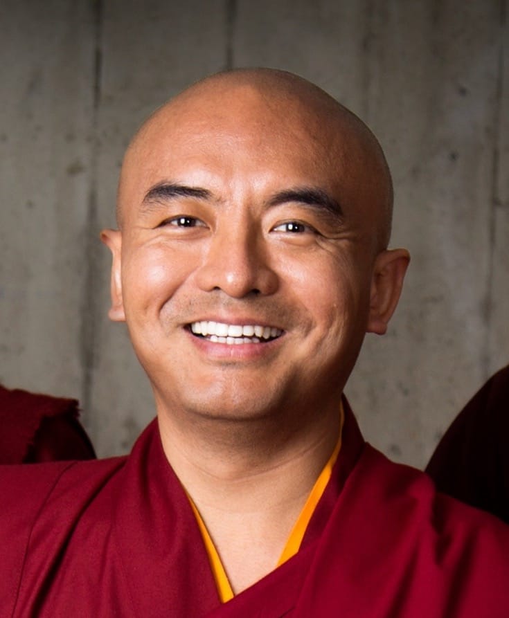 A portrait of smiling Yongey Mingyur Rinpoche.