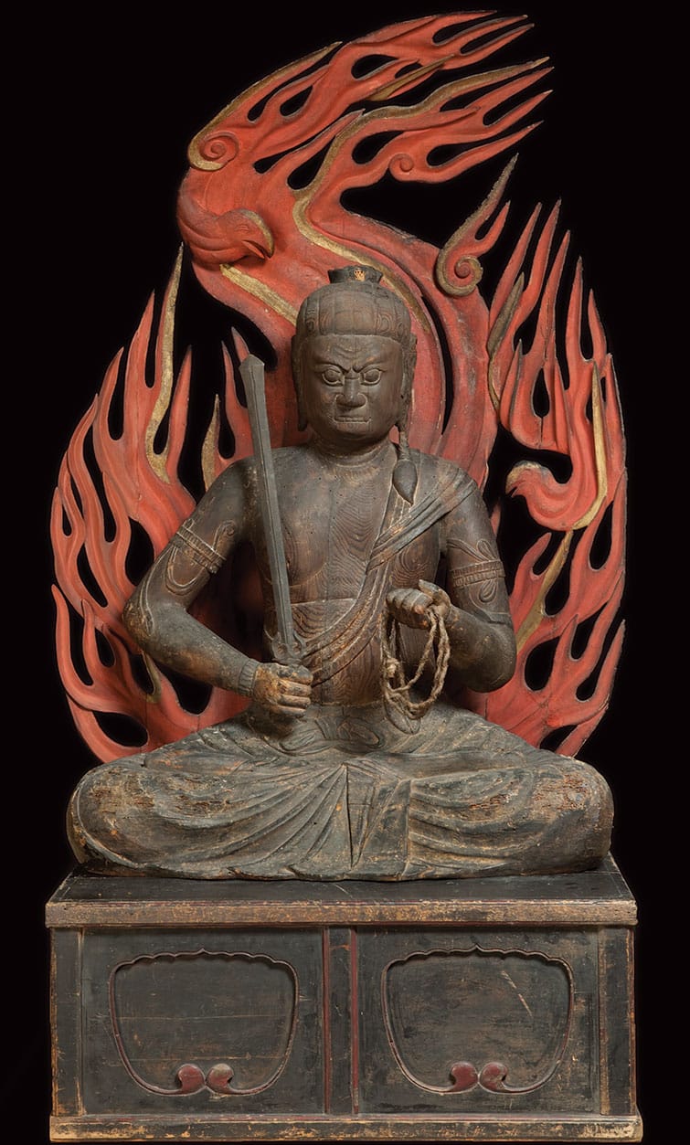 The protector Fudo statue. It is a person sitting in front of flames.