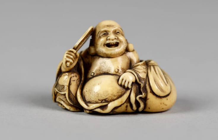 Small sculpture of Hotei, a fat, laughing monk, often mistaken for buddha