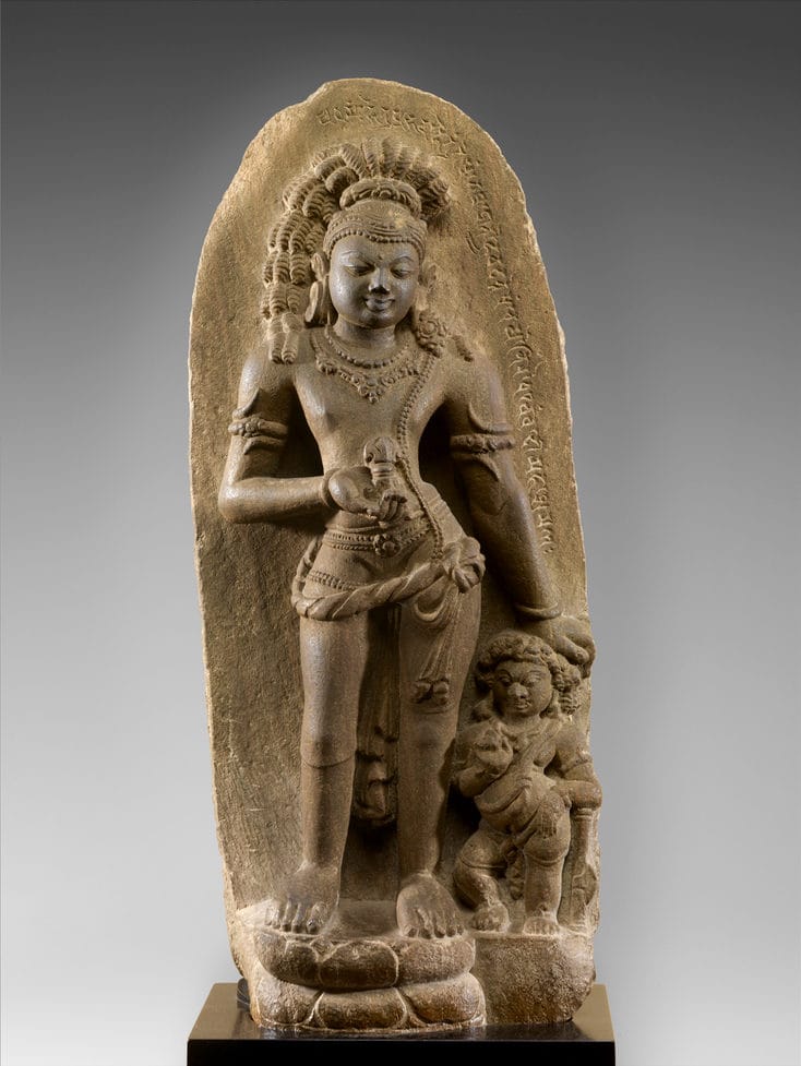 Vajrapani Bodhisattva standing. Statue against a grey background.