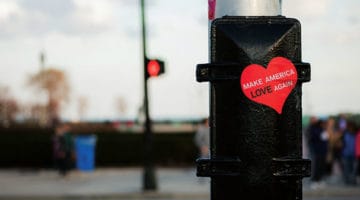 A sticker on a post that reads Make America Love Again