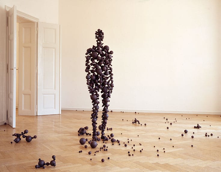 Person made out of orbs. They are scattering across the floor.