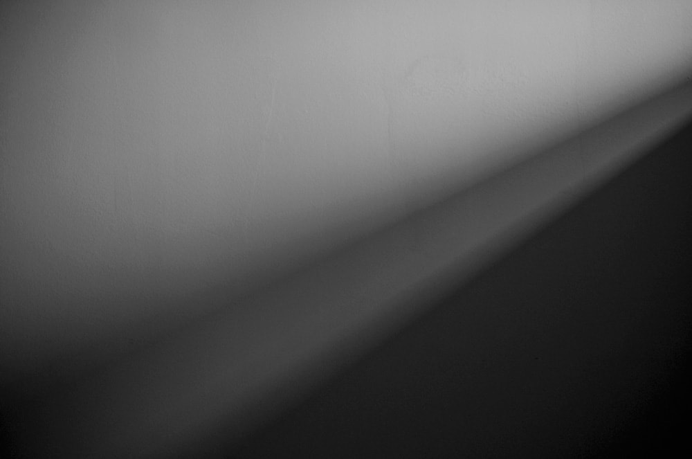 A grey and black plain wall.