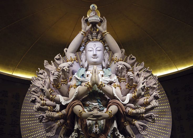 A photo of a statue of the thousand arms thousand eyes Guan Yin.