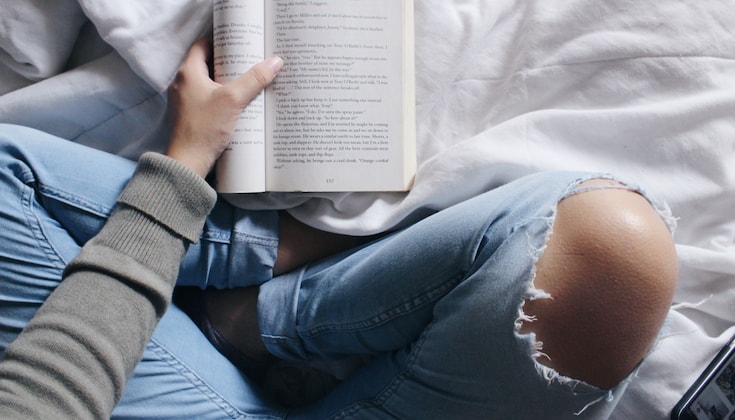 Reading book while meditating.