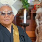 Portrait of Myokei Caine-Barrett by buddhist altar