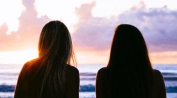 Two women watching sunet.