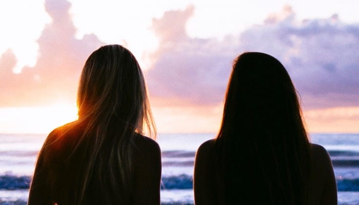 Two women watching sunet.