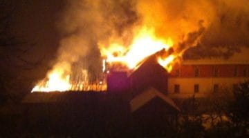 Building on fire in the night at Shangpa Karmaling.