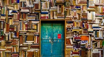 Wall of books with door.