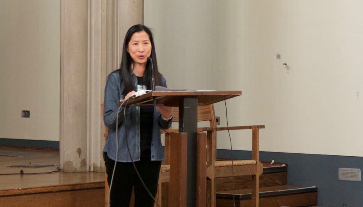 Rebecca Li speaking at a lectern.