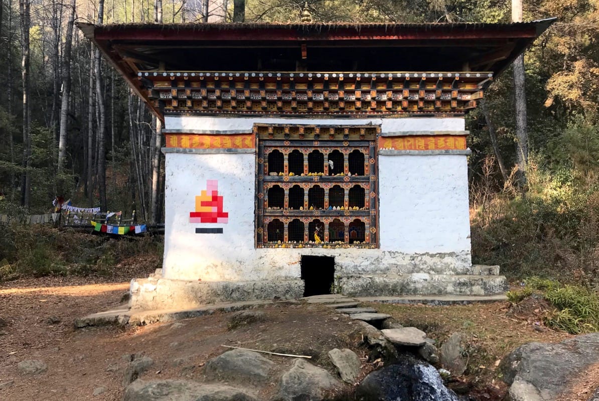 Mosaic of a Buddhist monk on side of a stupa.