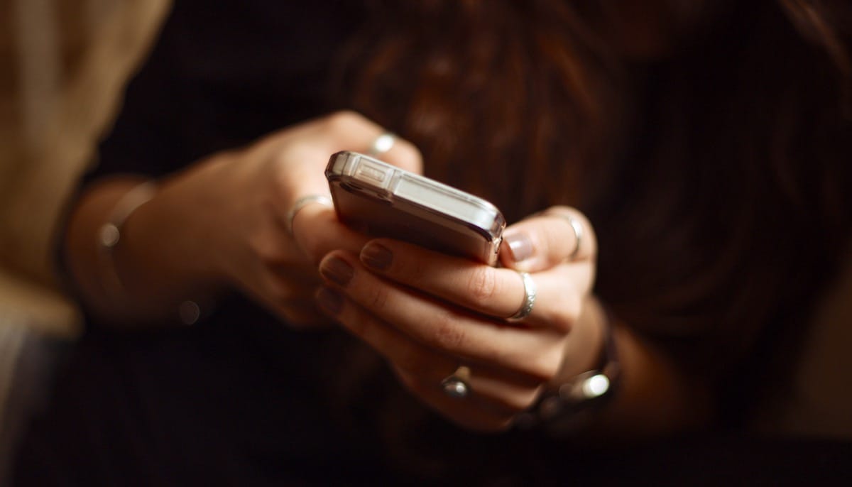 Woman holding cellphone.