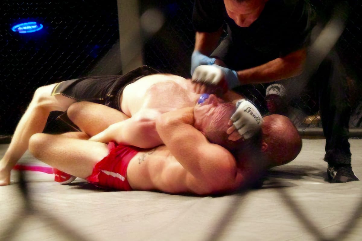 Choke hold in a cage match.