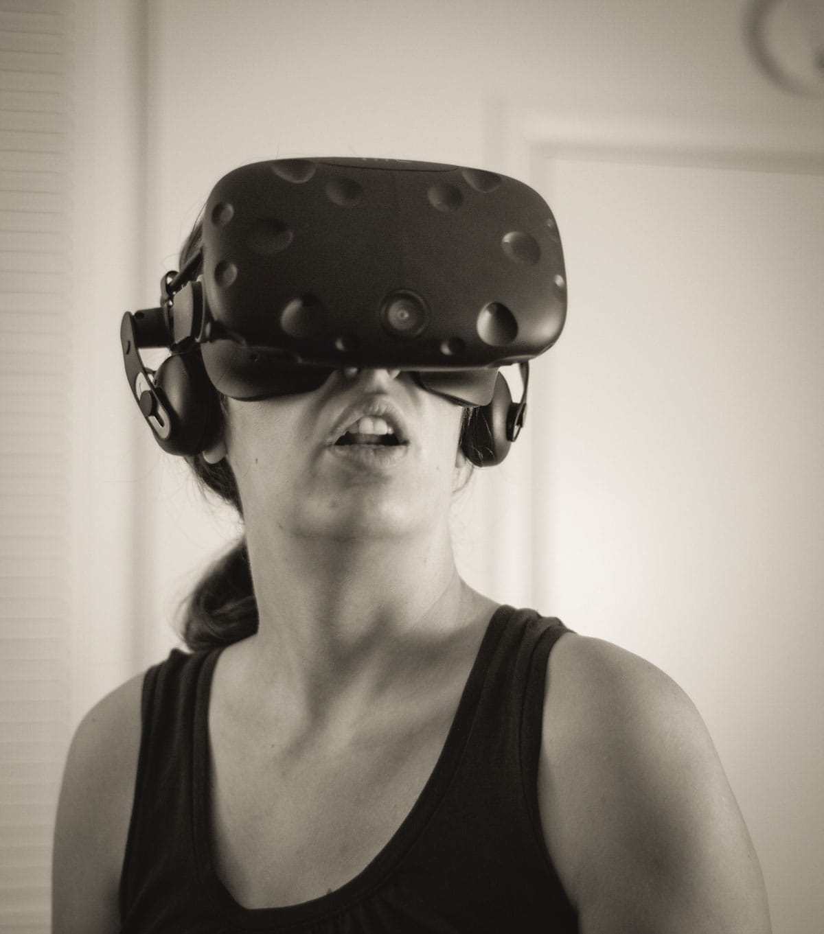 A black and white photograph of a person with virtual reality goggles.