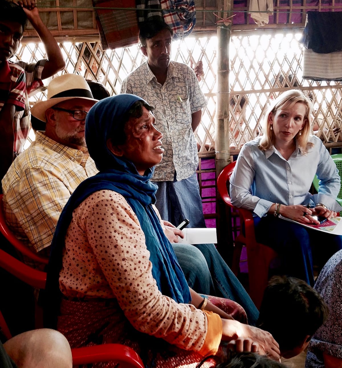 Distressed Rohingya woman talking to reporters in a camp.