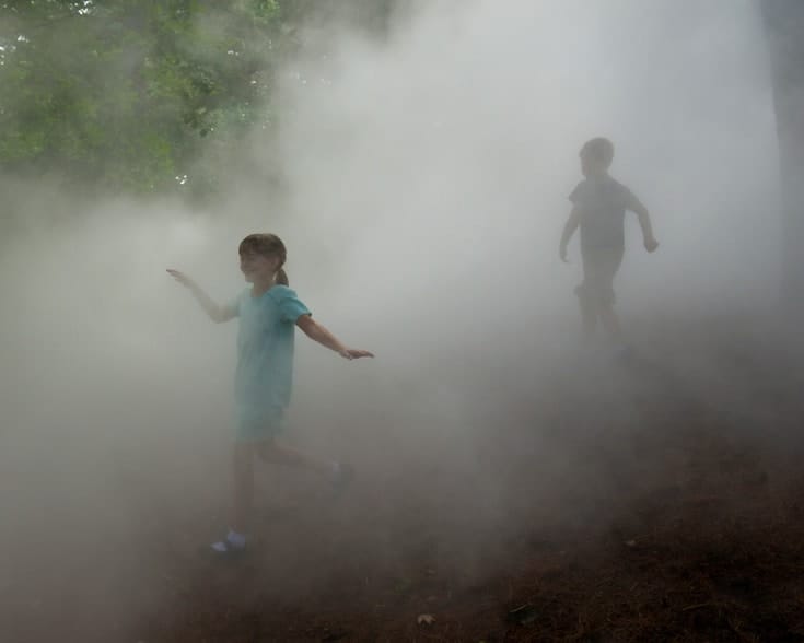 Children playing in fog.