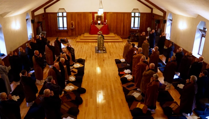 Dozens of priests gathered in a shrine hall.